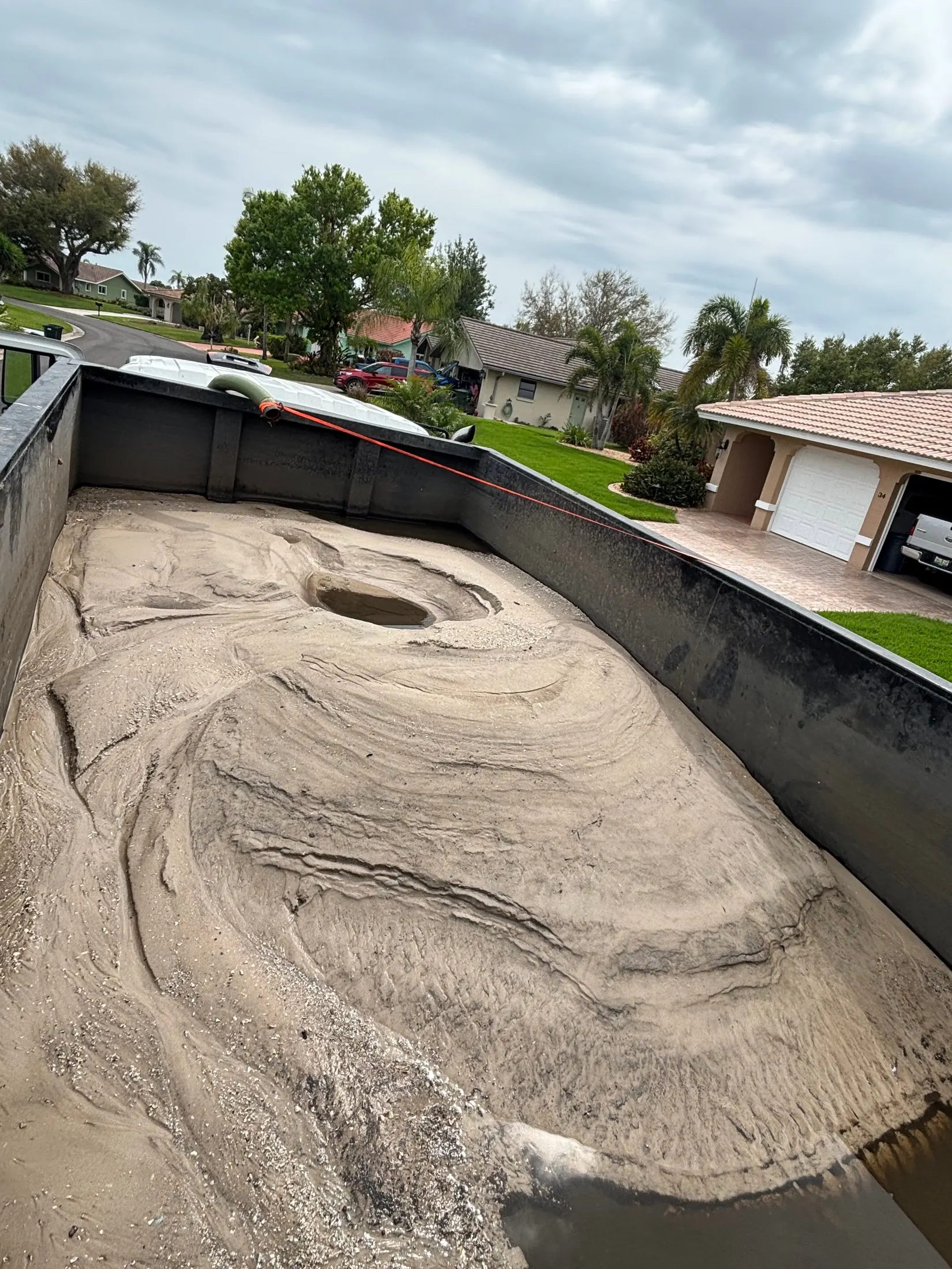 Dock & Dredge: sediment collected in an open container