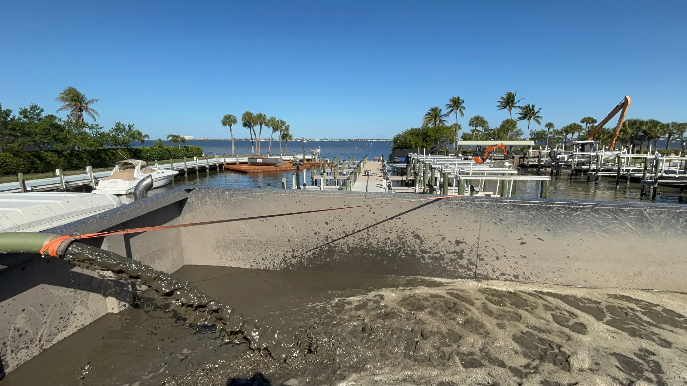Dock & Dredge: sediment-laden water entering a holding container near the waterfront