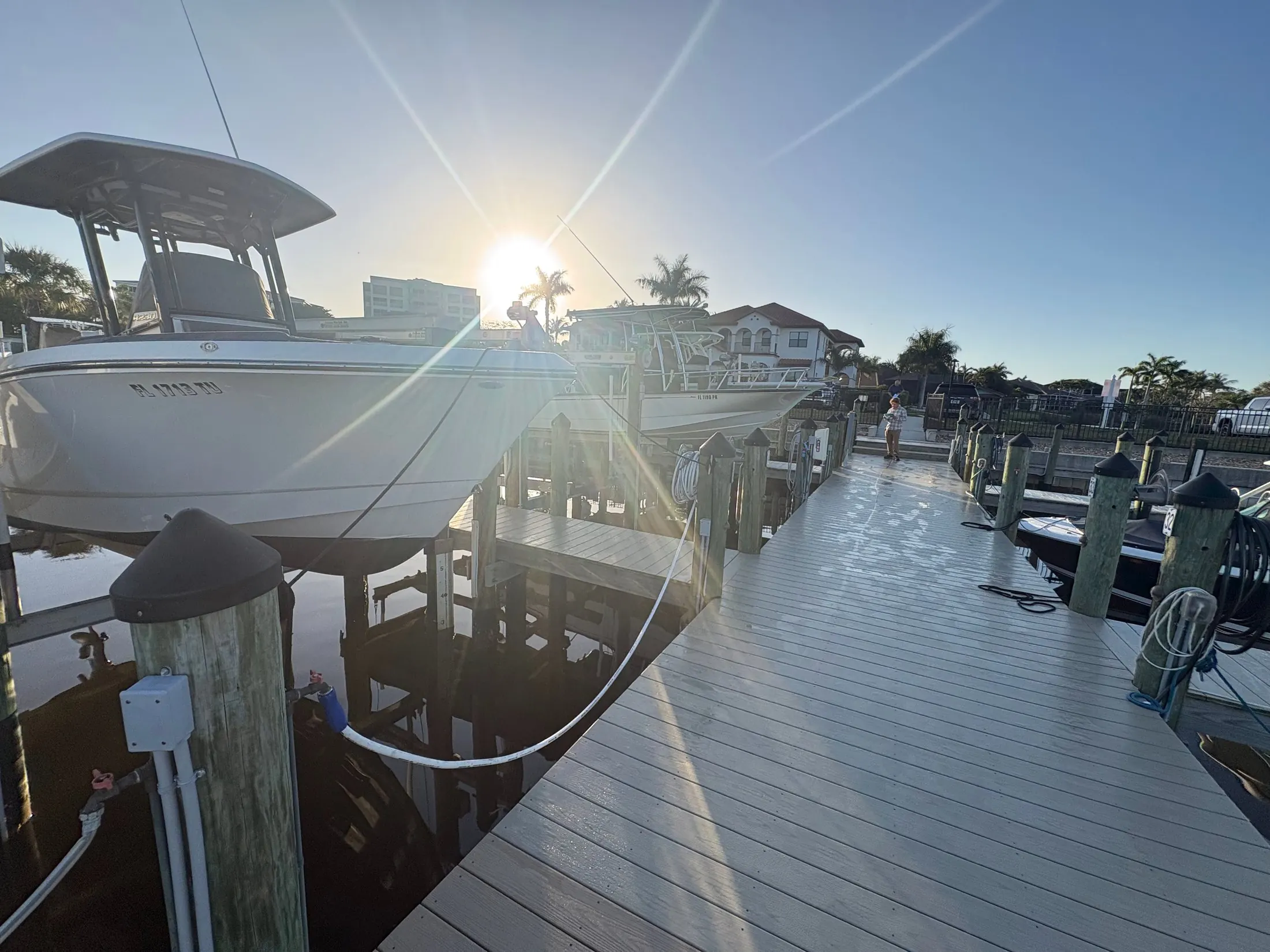 Dock & Dredge: boat lift and waterfront dock in low sunlight