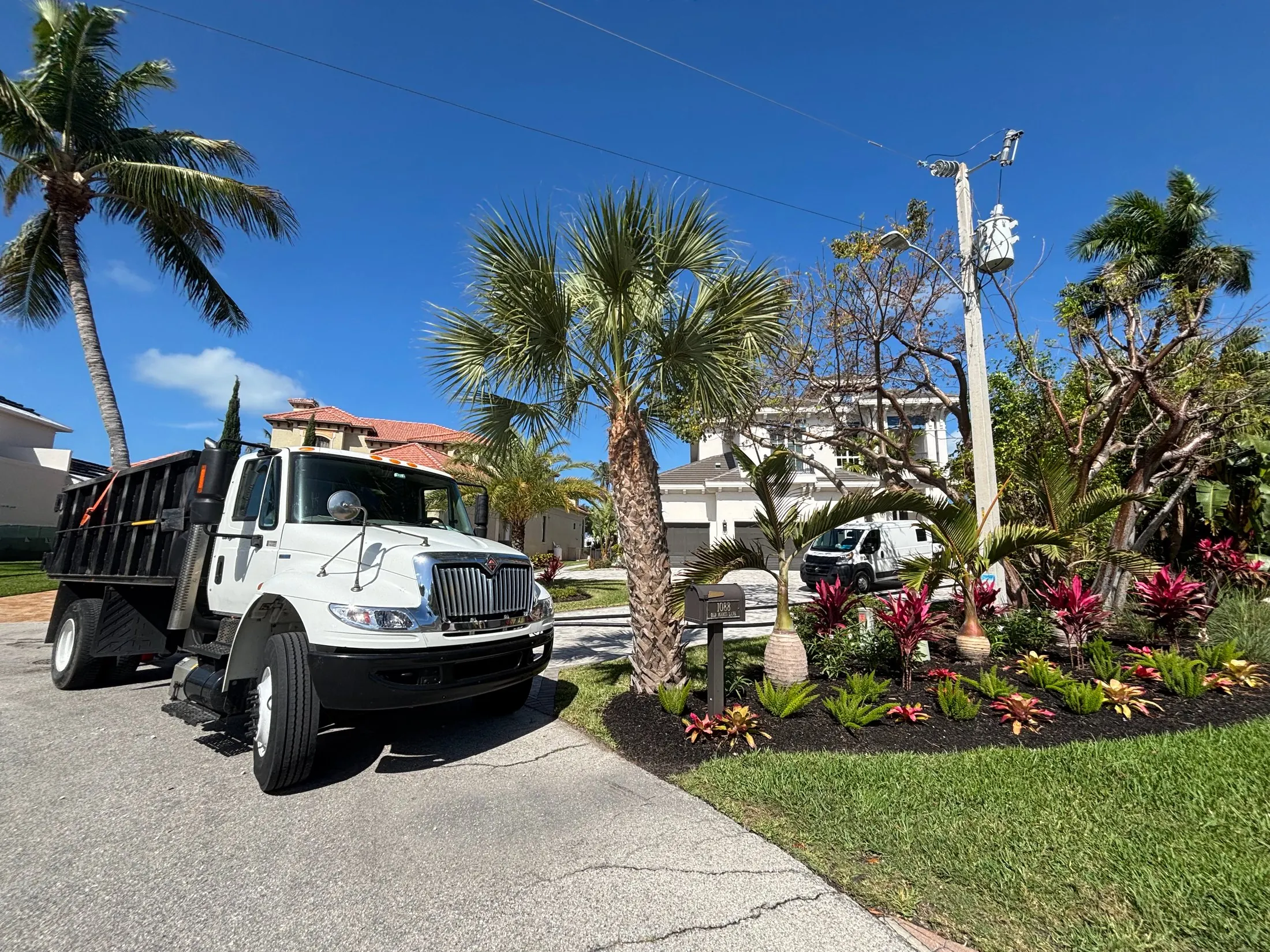 Dock & Dredge: dump truck parked beside a landscaped driveway